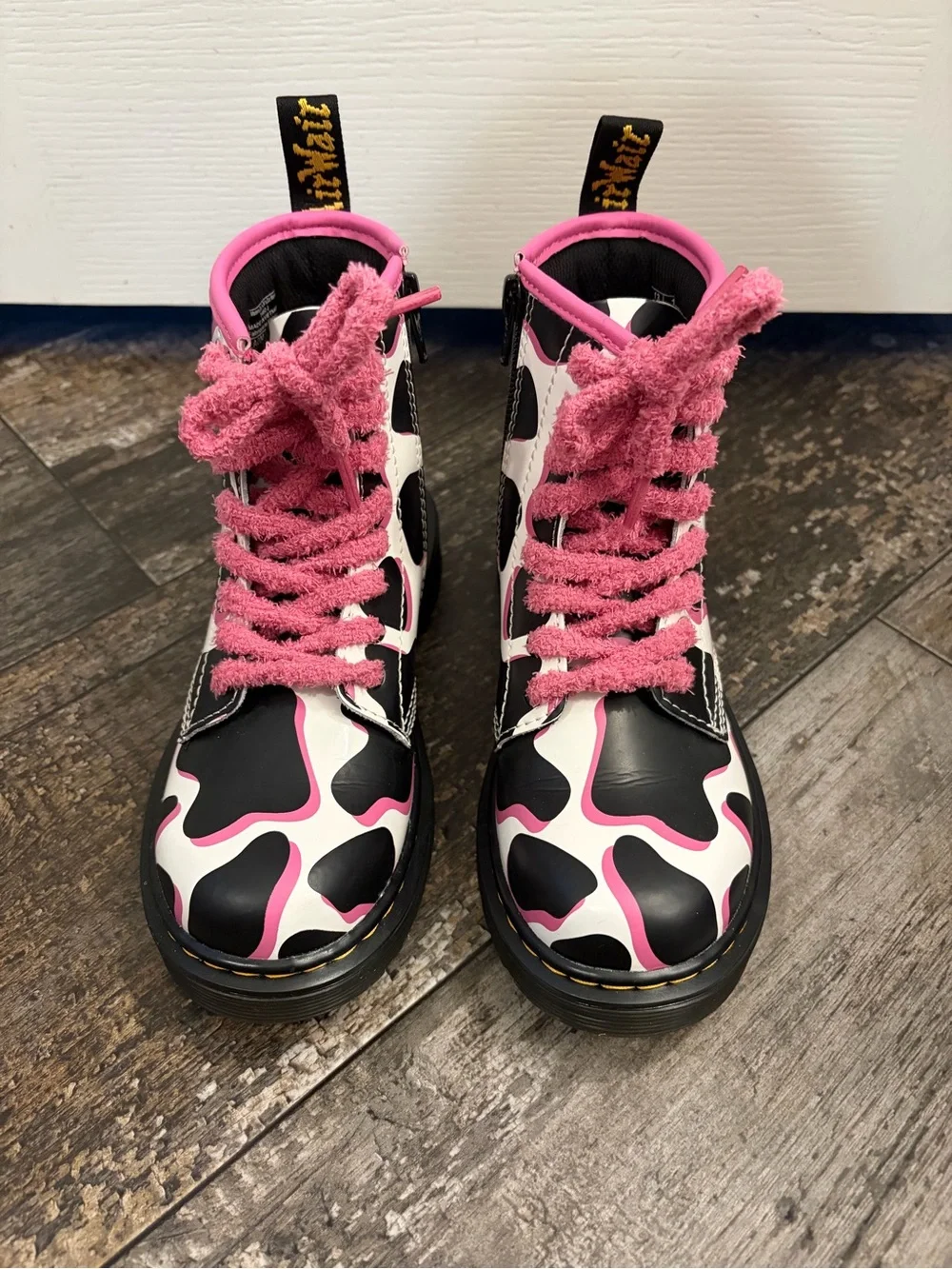 Dr Martin’s Black & White Cow Print Combat Boots with Pink Trim and Laces
